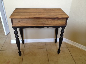 Stripped and restained desk with black legs.