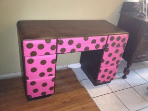 Brown desk with pink & polka dot drawers.